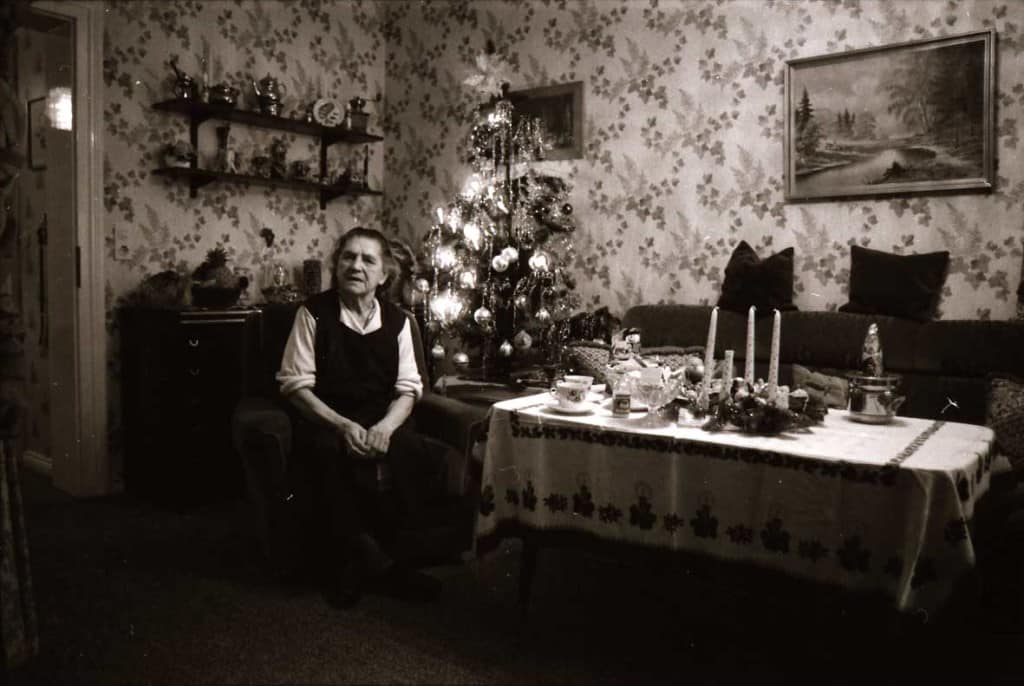 One of the random joys of travel. An 82 year-old shows us her living room, decorated for Christmas in Hamburg, 1984.. There is a Xmas tree with lights in the corner, and candles on the table.