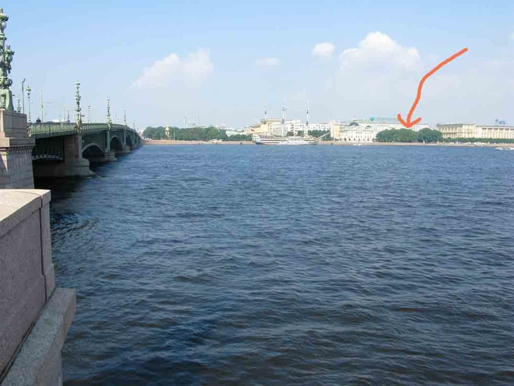 View from the south bank of the Neva across to where Peter the Great's original log cabin is now behind some trees (red arrow).