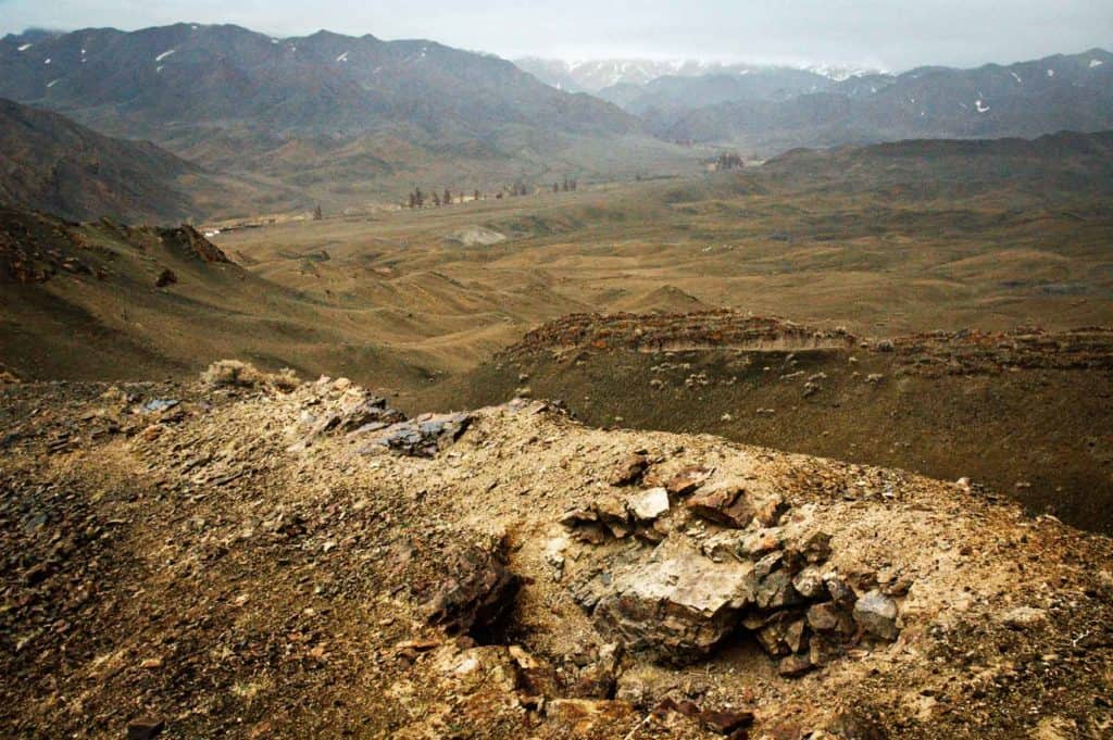 Foxholes in which ten Mongolian soldiers fought to the death, line a ridge in the far southwest of Mongolia. They fought against an overwhelming force who attacked from China (in the background of this image).