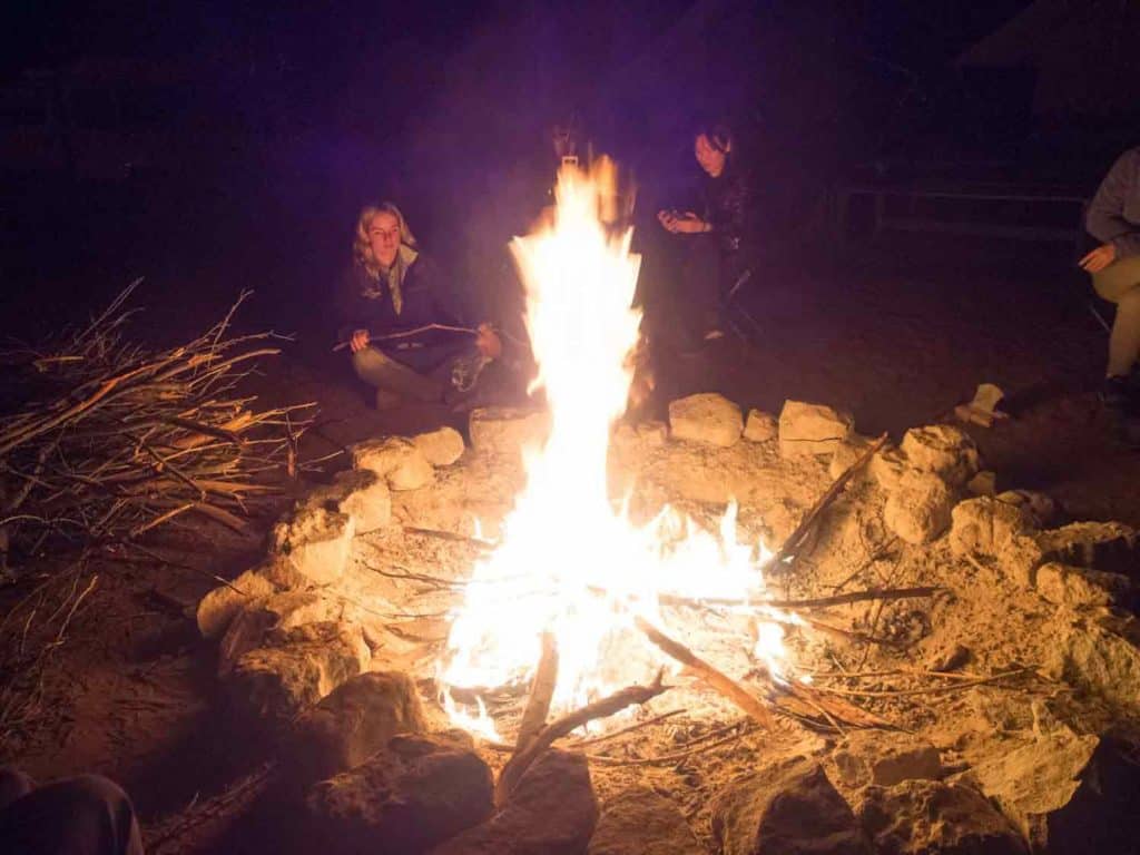 Simple pleasures: sitting around a camp fire at Emu Run Tours private camp near Kings Canyon. central Australia.